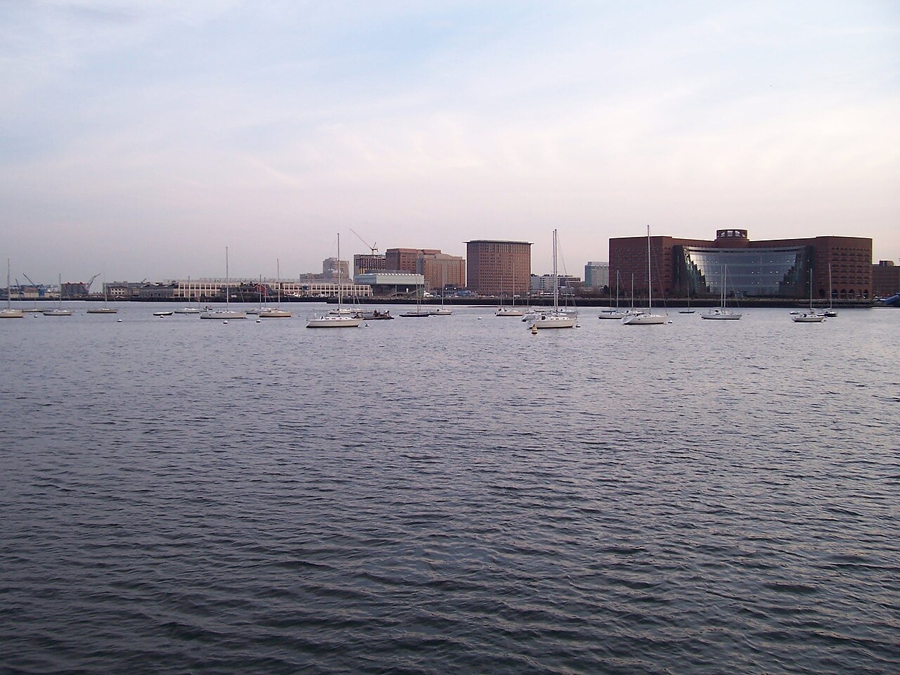 The modern glass towers of Boston's Seaport District rising along the harbor waterfront.